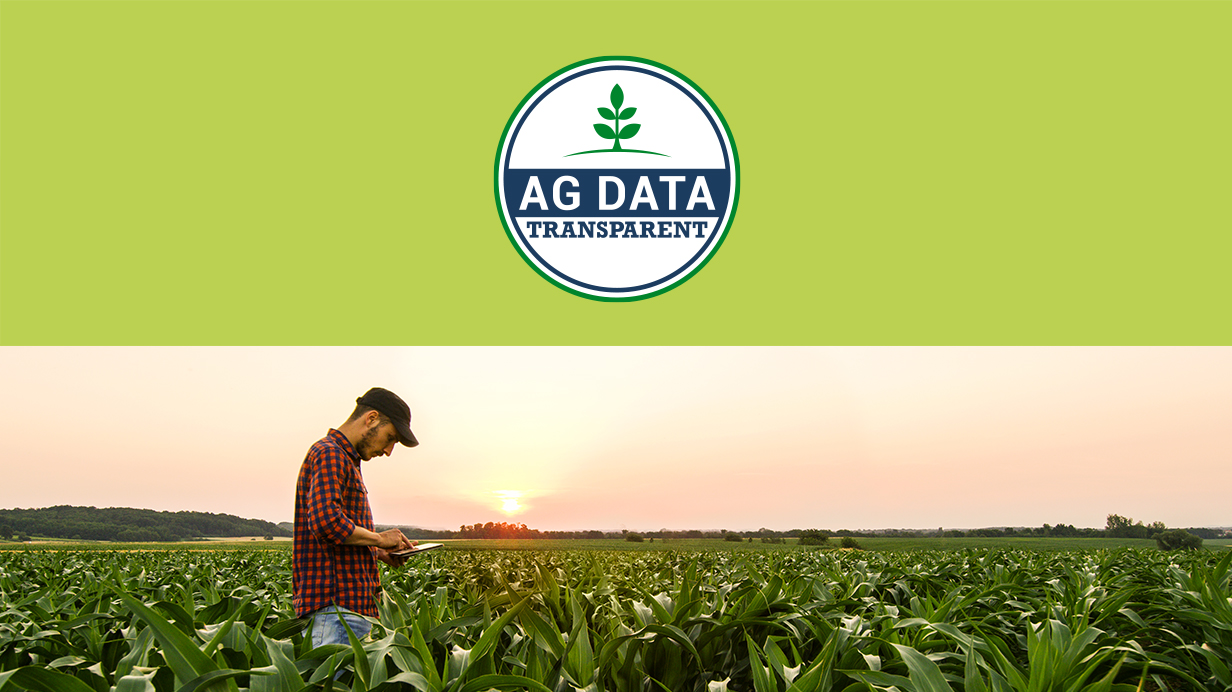 A man and his tablet in a cornfield with the Ag Data Transparent logo