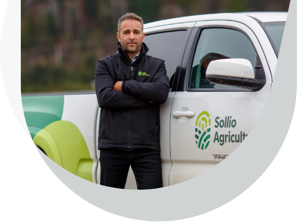 An employee in front of a Sollio Agriculture van.