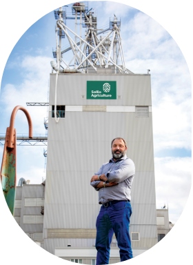A Sollio Agriculture employee in front of a feed mill.