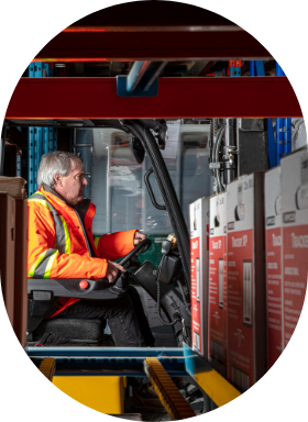 An employee operating a forklift in a Sollio Agriculture factory.