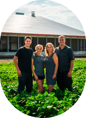 A farming family in a field working to feed the world.