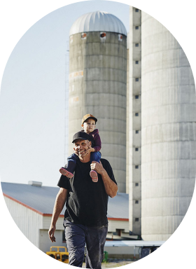 Father and son in front of a barn