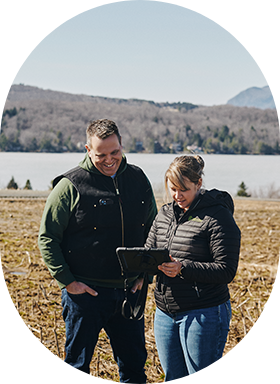 Un producteur et son experte-conseil en agroenvironnement récoltent des données au champ sur une tablette. 